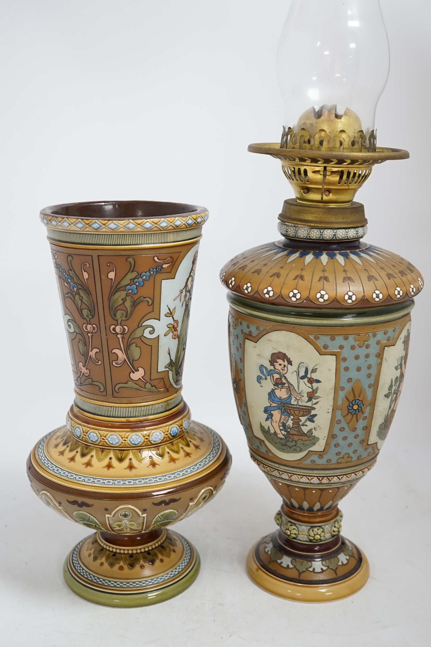 A Mettlach stoneware oil lamp and a similar Mettlach vase, largest 58cm high. Condition - good